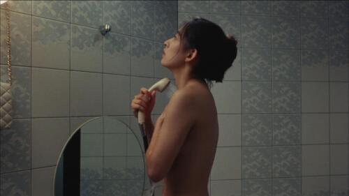 Rei is taking a shower at an outcall in a love hotel in Tokyo. Her purse hangs on a hook near the shower head holder.